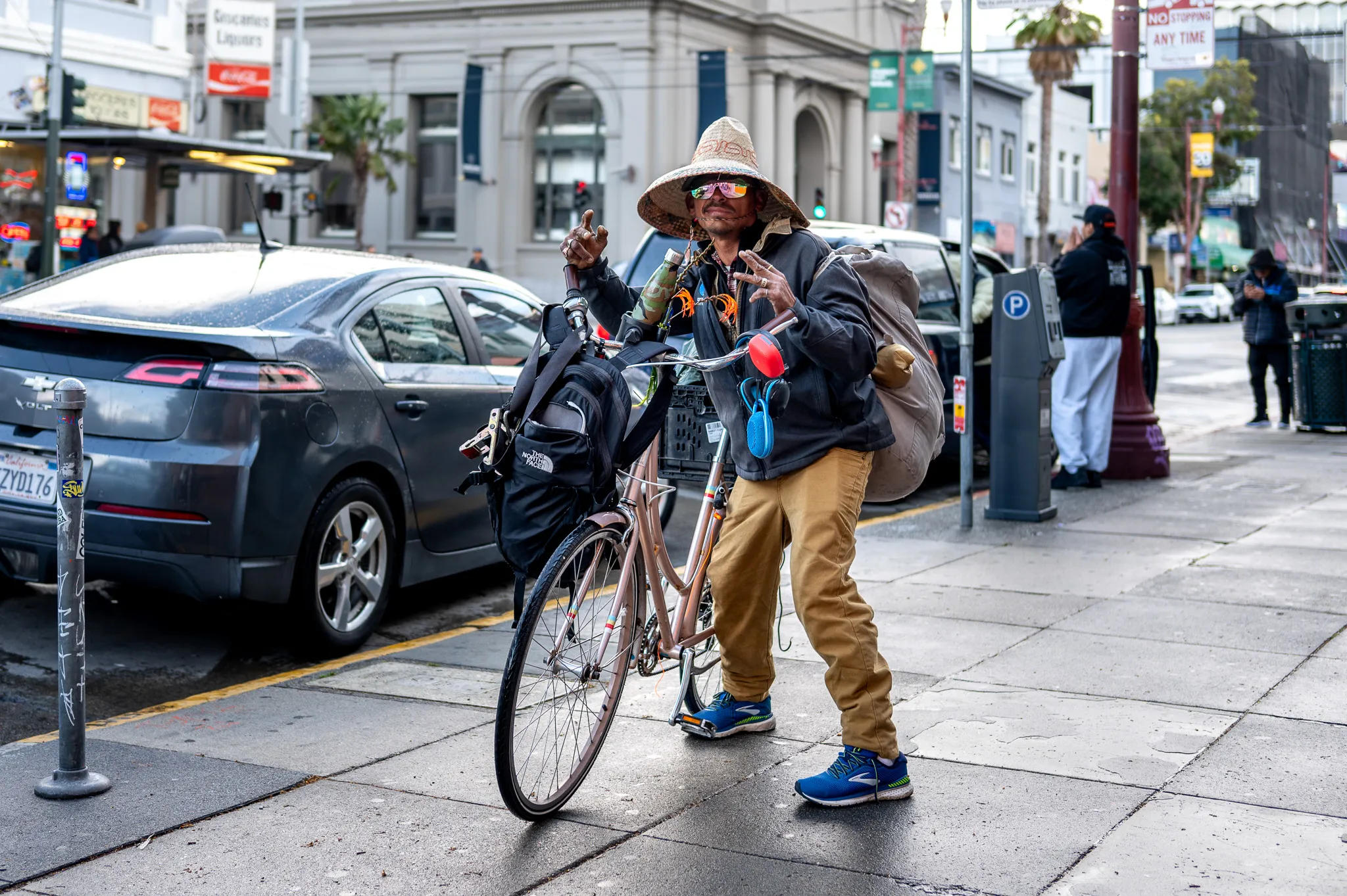 a man stand next to his bicycle